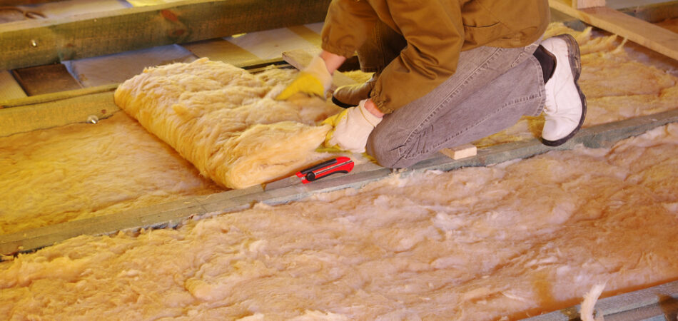 Construction,worker,thermally,insulating,house,attic,with,glass,wool
